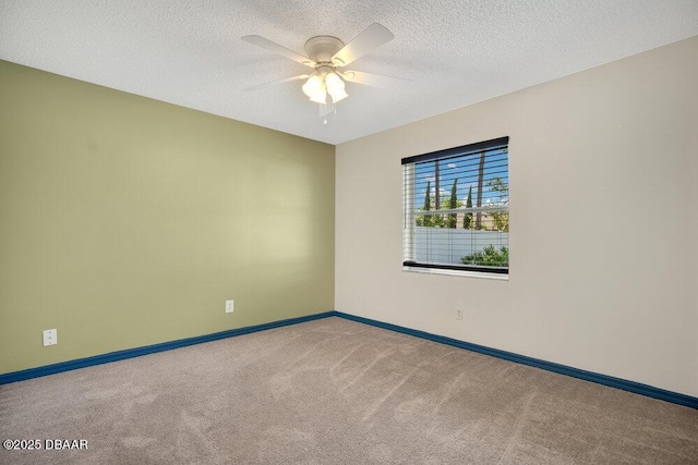 carpeted empty room featuring ceiling fan and a textured ceiling