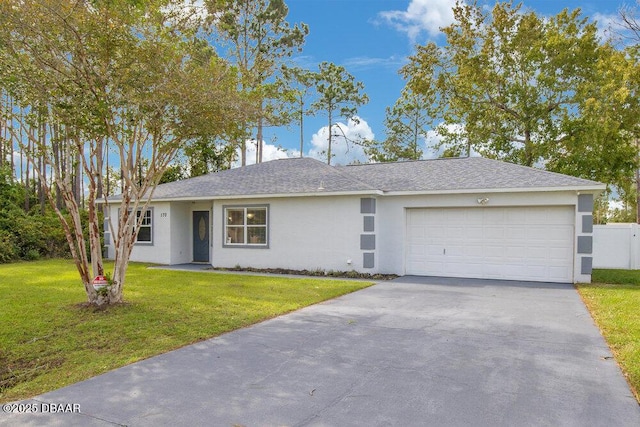 single story home with a garage and a front lawn