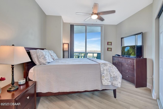241 Riverside Dr Unit 410, Holly Hill, FL 32117 - bedroom with multiple windows, access to exterior, light wood-style flooring, and a ceiling fan