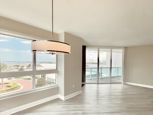 241 Riverside Dr Unit 410, Holly Hill, FL 32117 - empty room with a textured ceiling, baseboards, and wood finished floors