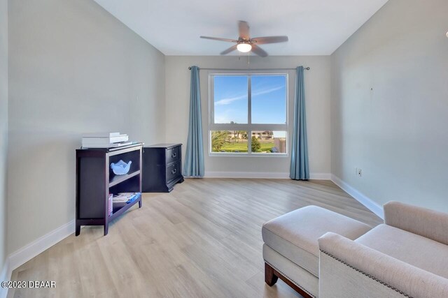 241 Riverside Dr Unit 410, Holly Hill, FL 32117 - living area featuring a ceiling fan, baseboards, and light wood-style floors