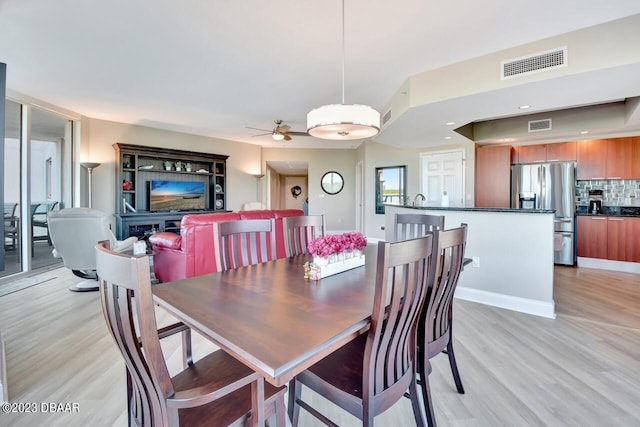 241 Riverside Dr Unit 410, Holly Hill, FL 32117 - dining space featuring light wood-style flooring and ceiling fan