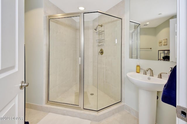 241 Riverside Dr Unit 410, Holly Hill, FL 32117 - bathroom featuring tile patterned floors, a stall shower, and baseboards