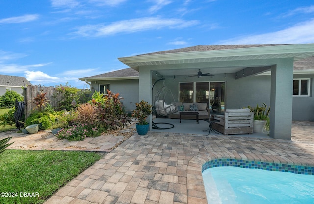 1934 NW 79th Loop, Ocala, FL 34475 - back of house with a ceiling fan, outdoor lounge area, a patio, stucco siding, and a shingled roof