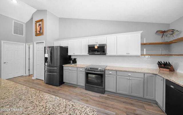 1934 NW 79th Loop, Ocala, FL 34475 - kitchen featuring stainless steel appliances, gray cabinetry, tasteful backsplash, light wood-style floors, and high vaulted ceiling