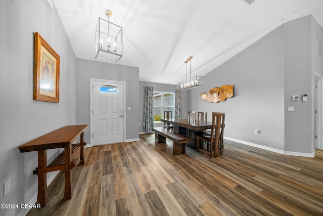 dining space with dark hardwood / wood-style flooring and lofted ceiling