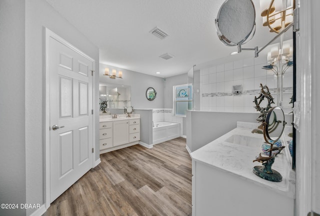 1934 NW 79th Loop, Ocala, FL 34475 - full bath with two vanities, wood finished floors, a garden tub, and a chandelier
