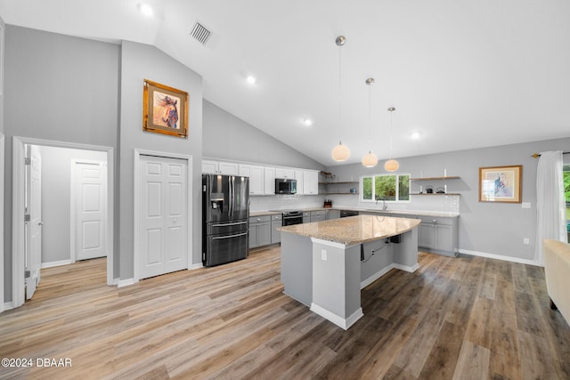 1934 NW 79th Loop, Ocala, FL 34475 - kitchen with appliances with stainless steel finishes, open shelves, a sink, a kitchen island, and high vaulted ceiling