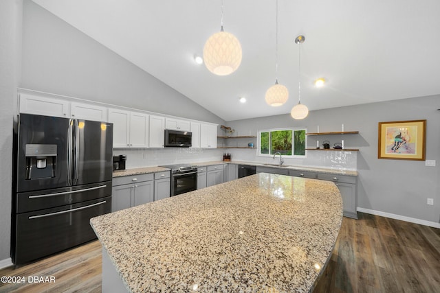 1934 NW 79th Loop, Ocala, FL 34475 - kitchen featuring stainless steel appliances, open shelves, a sink, backsplash, and lofted ceiling