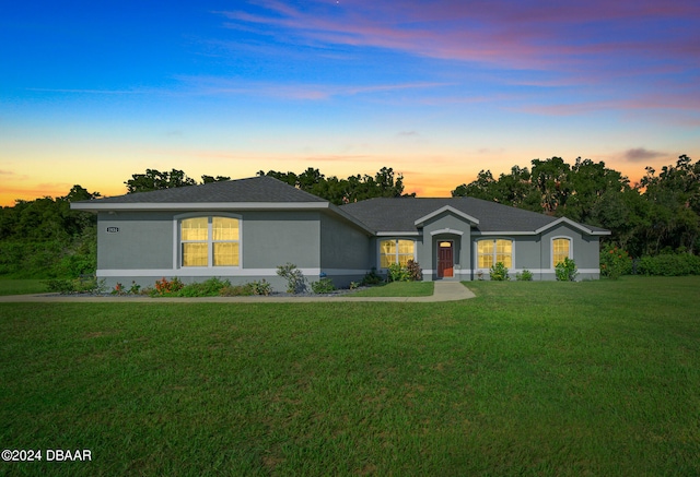 single story home with a yard