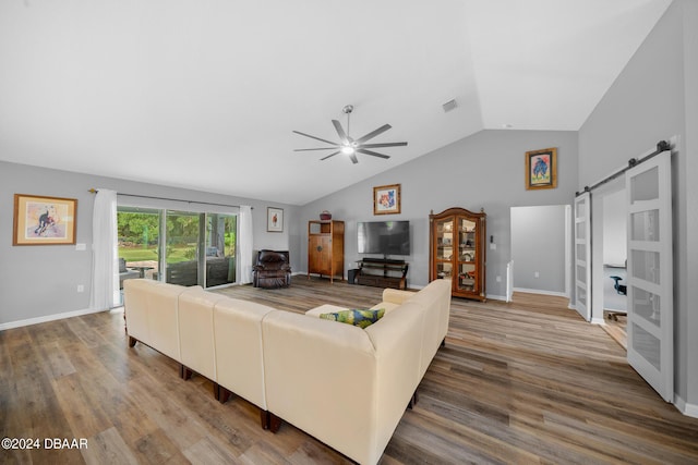 1934 NW 79th Loop, Ocala, FL 34475 - living area featuring a barn door, a ceiling fan, lofted ceiling, wood finished floors, and baseboards