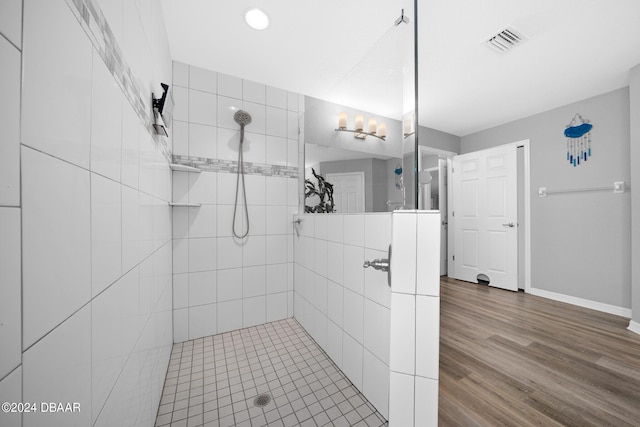 1934 NW 79th Loop, Ocala, FL 34475 - bathroom with tiled shower, baseboards, and wood finished floors
