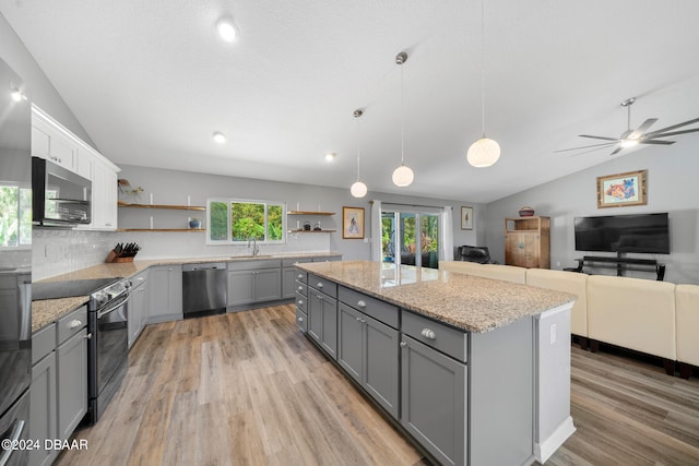 kitchen with pendant lighting, stainless steel appliances, lofted ceiling, and gray cabinetry