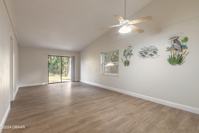 unfurnished room with ceiling fan, light hardwood / wood-style floors, and lofted ceiling