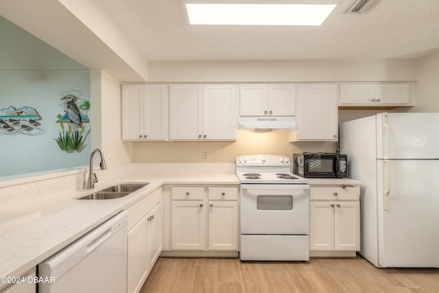 kitchen with white cabinetry, sink, light hardwood / wood-style floors, a textured ceiling, and white appliances