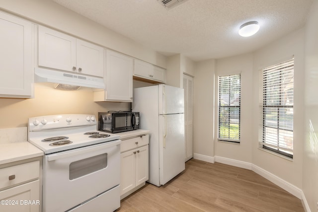 kitchen with a textured ceiling, white cabinets, light hardwood / wood-style floors, and white appliances