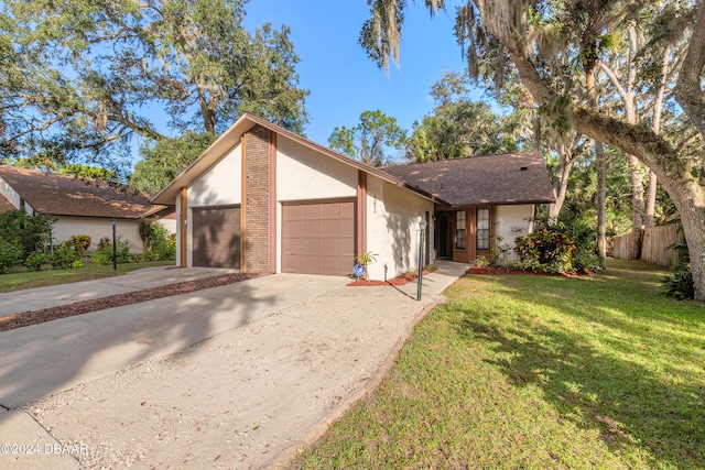 ranch-style house with a garage and a front lawn