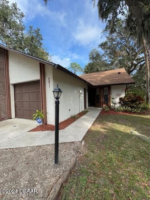 view of front of house with a garage and a front lawn