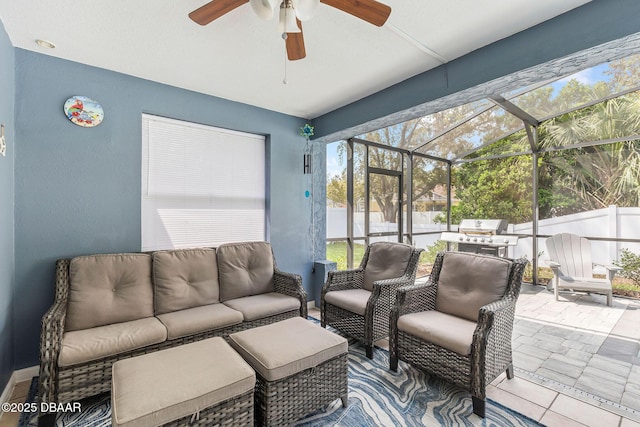 view of patio with area for grilling, fence, glass enclosure, an outdoor hangout area, and ceiling fan