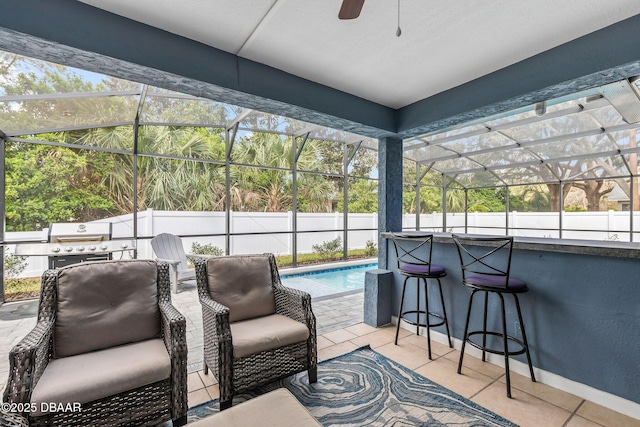 view of patio featuring a ceiling fan, a fenced in pool, an outdoor kitchen, a lanai, and outdoor dry bar