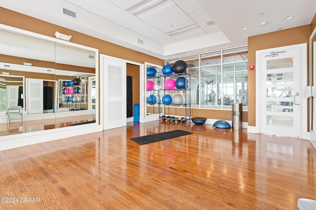 231 Riverside Dr Unit 1106-1, Holly Hill, FL 32117 - workout area with wood finished floors, a raised ceiling, and baseboards