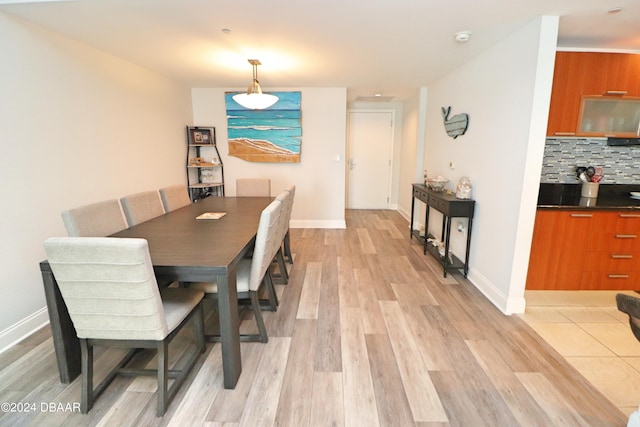 dining space with light hardwood / wood-style flooring