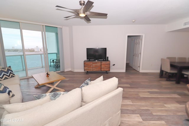 231 Riverside Dr Unit 1106-1, Holly Hill, FL 32117 - living area with floor to ceiling windows, a ceiling fan, wood finished floors, and baseboards