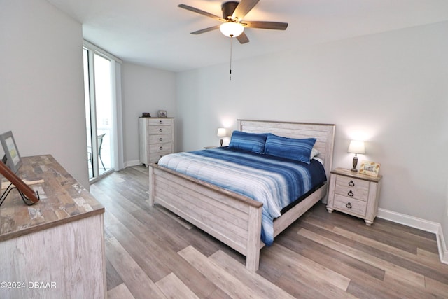231 Riverside Dr Unit 1106-1, Holly Hill, FL 32117 - bedroom with wood finished floors, baseboards, and a ceiling fan