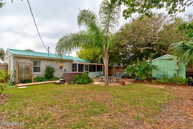 view of yard with a patio area, a sunroom, and a storage unit