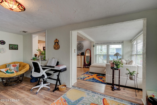 office space featuring light hardwood / wood-style floors and a textured ceiling