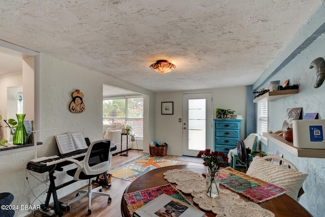 interior space with light wood-type flooring and a textured ceiling