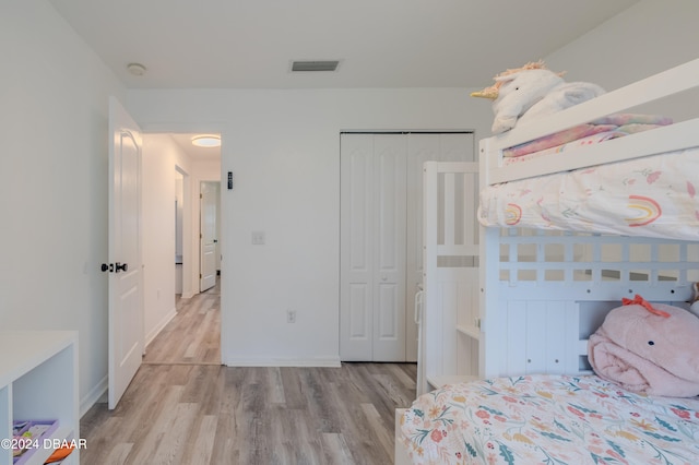 bedroom featuring a closet and light wood-type flooring