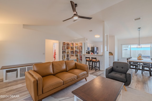 living room with light wood-type flooring, lofted ceiling, and ceiling fan