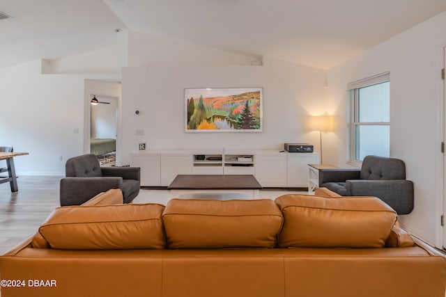 living room featuring light hardwood / wood-style floors and vaulted ceiling