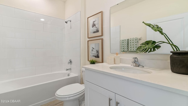 full bathroom with vanity, wood-type flooring, tiled shower / bath combo, and toilet