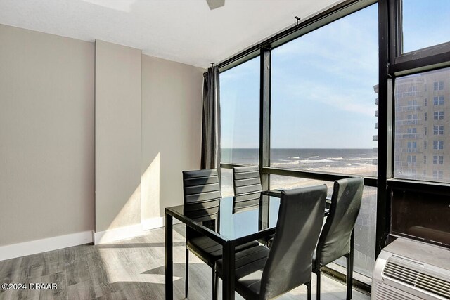 sunroom featuring a water view