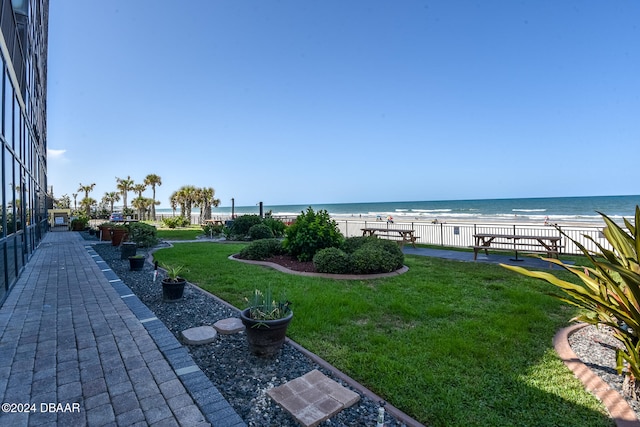 view of yard featuring a water view and a view of the beach