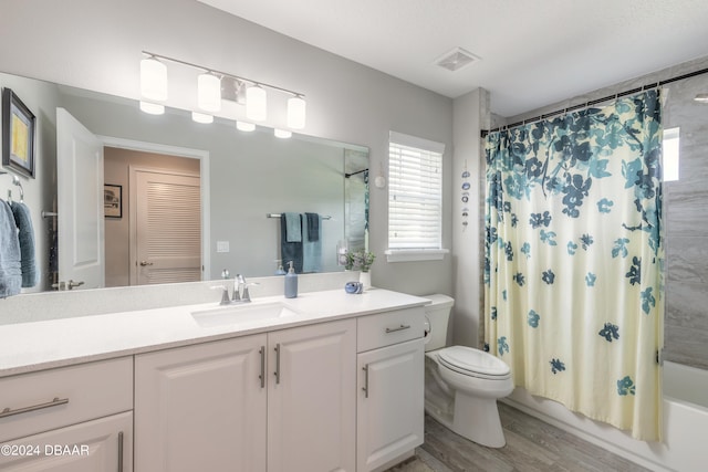 full bathroom featuring shower / bathtub combination with curtain, vanity, toilet, and wood-type flooring