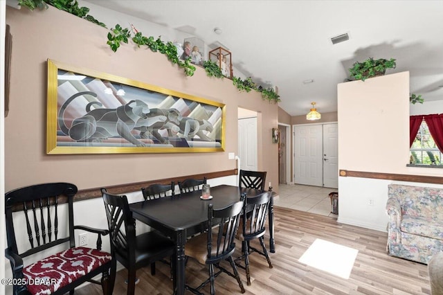 771 Arroyo Pkwy, Ormond Beach, FL 32174 - dining space featuring wood finished floors, vaulted ceiling, and baseboards