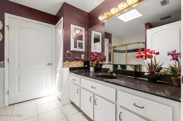 771 Arroyo Pkwy, Ormond Beach, FL 32174 - bathroom with tile patterned flooring, vanity, a stall shower, and a skylight