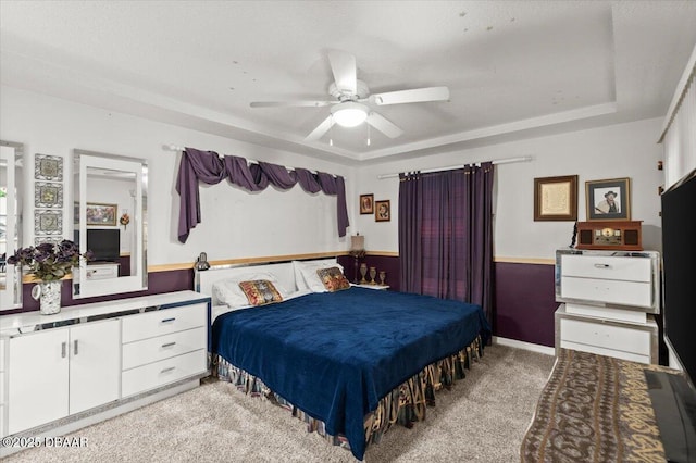 771 Arroyo Pkwy, Ormond Beach, FL 32174 - bedroom with light carpet, ceiling fan, and a tray ceiling