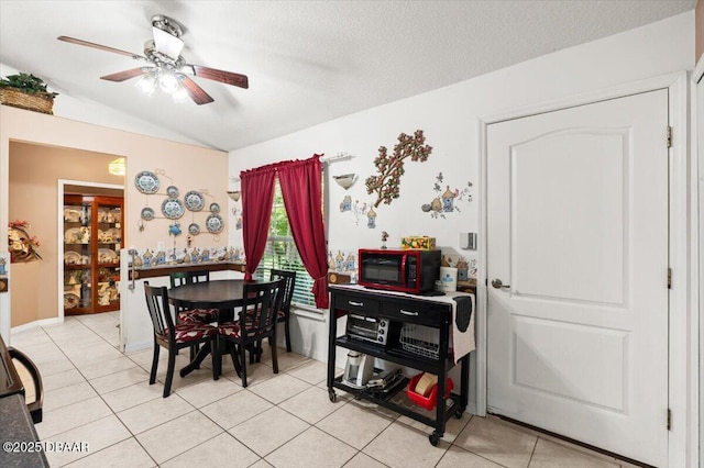 771 Arroyo Pkwy, Ormond Beach, FL 32174 - dining room with vaulted ceiling, a ceiling fan, and light tile patterned floors