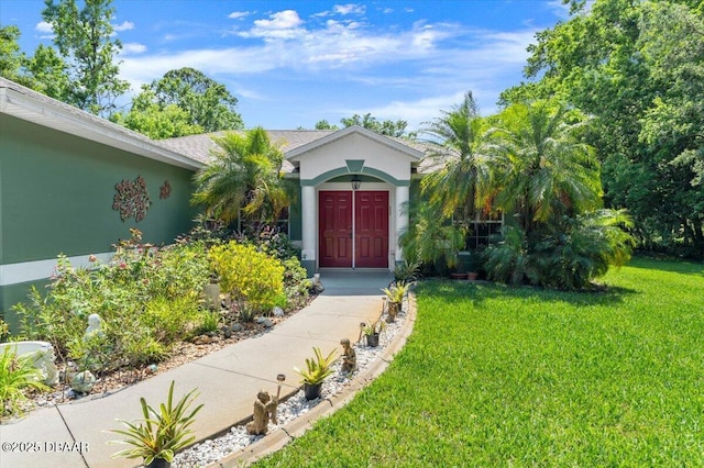 771 Arroyo Pkwy, Ormond Beach, FL 32174 - property entrance featuring a lawn and stucco siding