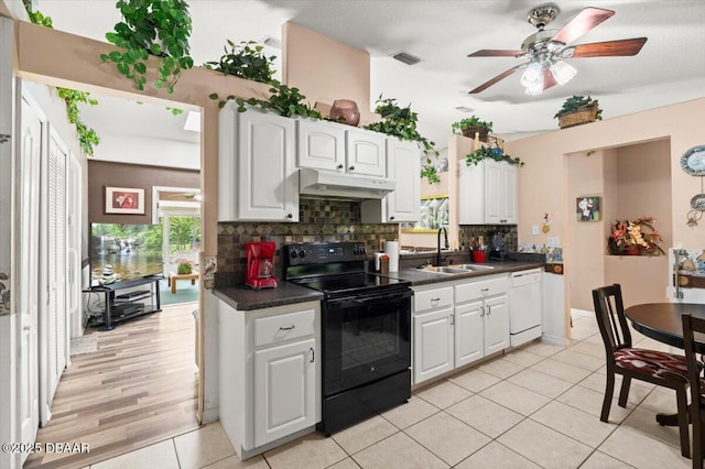771 Arroyo Pkwy, Ormond Beach, FL 32174 - kitchen featuring black range with electric cooktop, a sink, white dishwasher, under cabinet range hood, and dark countertops