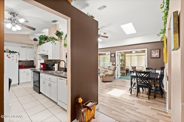 771 Arroyo Pkwy, Ormond Beach, FL 32174 - kitchen featuring white appliances, a ceiling fan, dark countertops, a sink, and tasteful backsplash