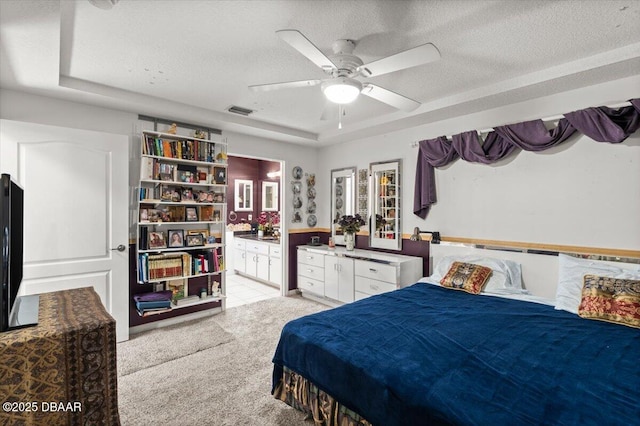 771 Arroyo Pkwy, Ormond Beach, FL 32174 - bedroom featuring light carpet, ensuite bath, a ceiling fan, and a textured ceiling