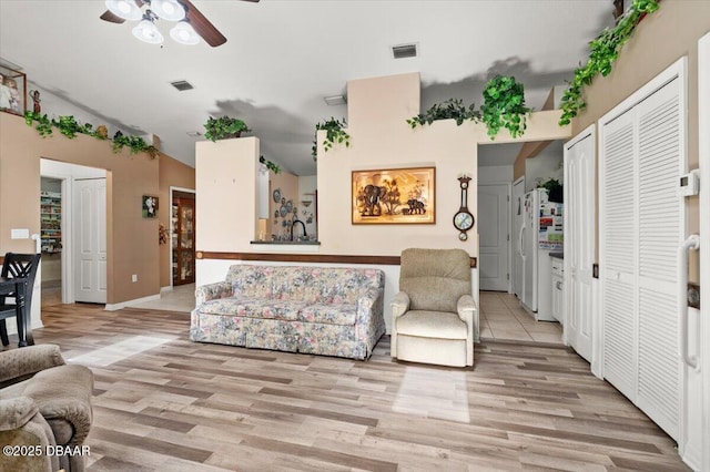 771 Arroyo Pkwy, Ormond Beach, FL 32174 - living room with a ceiling fan, light wood-style floors, lofted ceiling, and baseboards