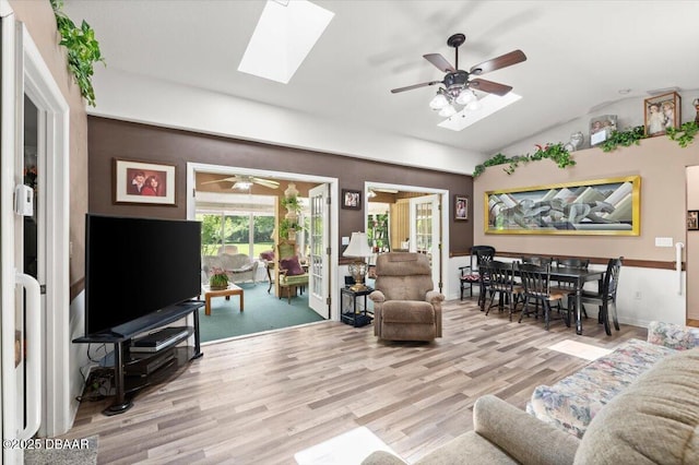 771 Arroyo Pkwy, Ormond Beach, FL 32174 - living room with ceiling fan, vaulted ceiling, a skylight, wood finished floors, and baseboards