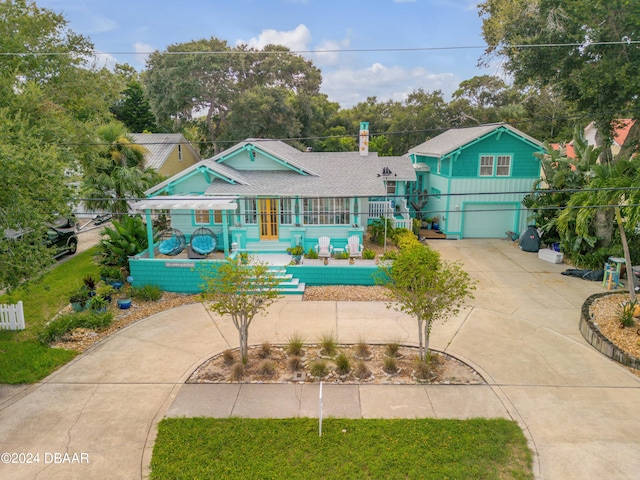 view of front of house featuring a garage and a porch