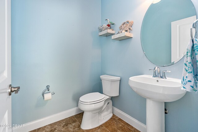 3651 Pini Ave, New Smyrna Beach, FL 32168 - bathroom featuring toilet and tile patterned floors